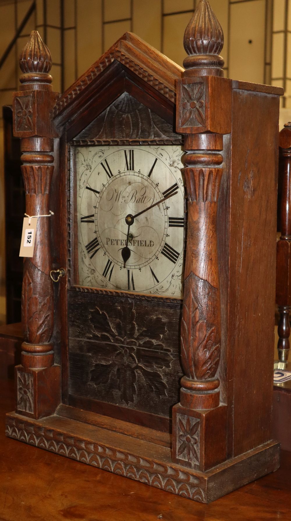 A 19th century single fusee clock movement, the 10in. silvered square dial marked William Batt, Petersfield, in associated carved oak c